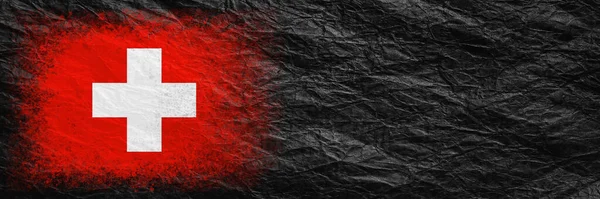 Flag of Switzerland. Flag is painted on black crumpled paper. Paper background. Copy space. Textured creative background