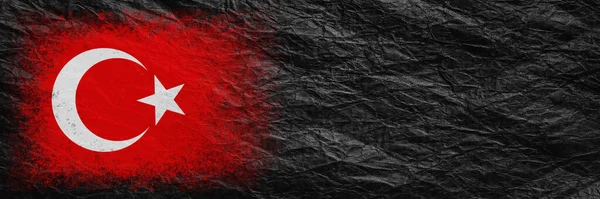Flag of Turkey. Flag is painted on black crumpled paper. Paper background. Copy space. Textured creative background