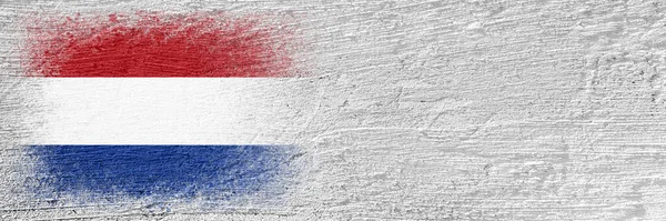 stock image Flag of Netherlands. Flag is painted on a cement wall. Cement background. Plastered surface. Copy space. Textured creative background