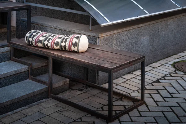 Street Cafe. Bench with cushion on the sidewalk. Close-up image