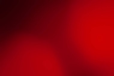 Red background. Blurred soft red background. Blurred colored abstract. Defocused image