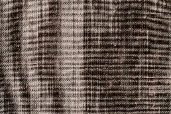 Fabric texture. Fabric background. Texture of rough brown fabric. Macro image from canvas pattern