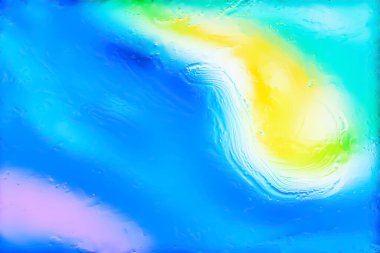Blurred abstract background. Abstract image of multi-colored blurry spots through wet glass. Texture of traces of water and oil on glass. Creative background