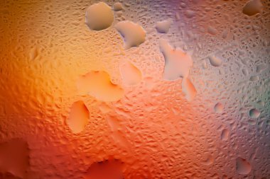 Abstract background. Abstract blur image of colored soft gradients and glare through wet glass. Texture of water drops on frozen glass. Creative background