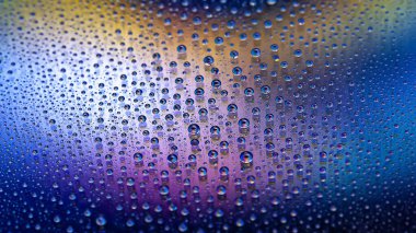 Drops of water. Abstract gradient background. The texture of the drops. Multicolored gradient. Textured image. Small depth of field. Selective soft focus
