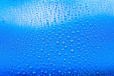Drops of water. Abstract gradient background. Drop texture. Blue gradient. Heavily textured image. Shallow depth of field. Selective soft focus