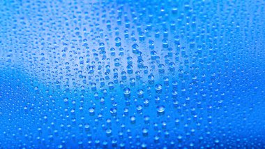 Water drops. Abstract gradient background. Drop texture. Blue gradient. Heavily textured image. Shallow depth of field. Selective soft focus