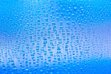 Water drops. Abstract gradient backdrop. Drop texture. Blue gradient. Heavily textured image. Shallow depth of field. Selective soft focus