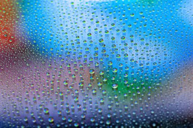 Drops of water. Abstract gradient background. Droplet texture. Multicolored gradient. Heavily textured image. Shallow depth of field. Selective soft focus