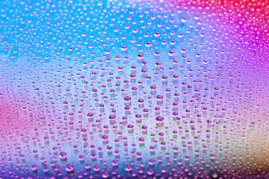 Water drops. Droplet texture. Abstract gradient background. Color rainbow gradient. A highly textured image. Shallow depth of field. Selective soft focus