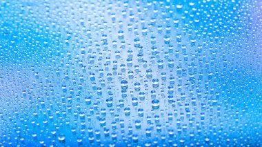 Drops of water. Abstract gradient backdrop. Drop texture. Blue gradient. Heavily textured image. Shallow depth of field. Selective soft focus