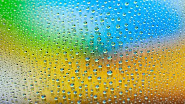 Water drops. Texture of the drops. Abstract gradient background. Colorful rainbow gradient. Heavily textured image. Shallow depth of field. Selective soft focus