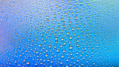 Water drops. Abstract gradient backdrop. Texture of the drops. Blue gradient. Heavily textured image. Shallow depth of field. Selective soft focus