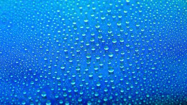 Water drops. Abstract gradient backdrop. Drop texture. Blue gradient. Heavily textured image. Small depth of field. Selective soft focus