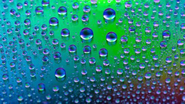 Water drops. Abstract gradient background. Droplet texture. Iridescent gradient. Heavily textured image. Small depth of field. Selective soft focus