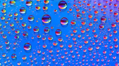 Water drops. Abstract gradient background. Droplet texture. Rainbow gradient. Heavily textured image. Shallow depth of field. Selective soft focus
