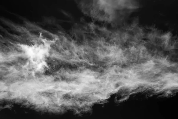 White clouds on a dark dramatic sky. Black and white sky template to create atmosphere