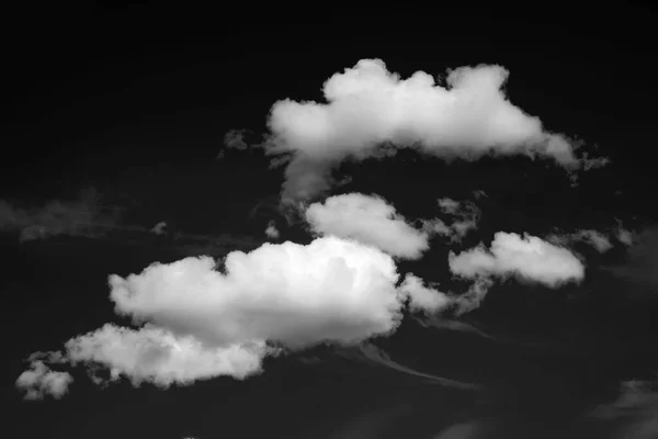 White clouds on a black background. Black and white sky pattern to create a dramatic atmosphere