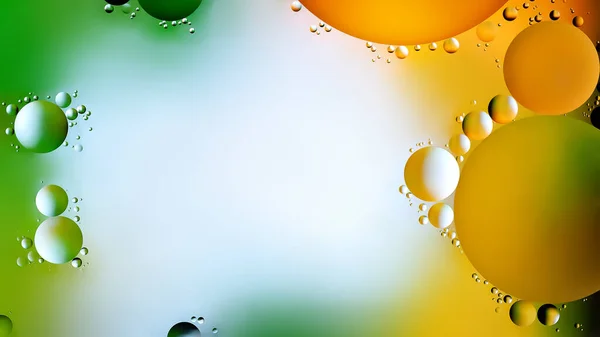 Drops of oil in water. Abstract rainbow background. Colored background of oil drops on the water surface. Copy space. Macro abstraction