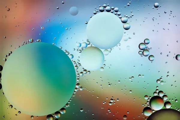 Drops of oil in water. Abstract iridescent background. Colored background of oil drops on the water surface. Macro abstraction