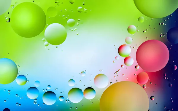 Abstract rainbow background. Drops of oil in water. Colored background of oil drops on the water surface. Macro abstraction
