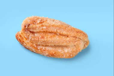 Biscuits isolated on blue. Cookies sprinkled with sugar. Crispy fresh baked goods. Soft focus