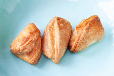 Biscuits on a blue plate. Cookies sprinkled with sugar. Crispy fresh baked goods. Soft focus