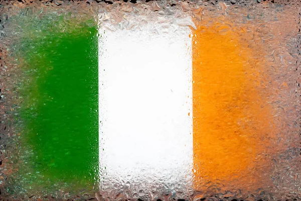Flag of Ireland. Flag of Ireland on the background of water drops. Flag with raindrops. Splashes on glass. Abstract background