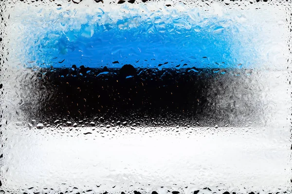 Estonia flag. Flag of Estonia on the background of water drops. Flag with raindrops. Splashes on glass. Abstract background