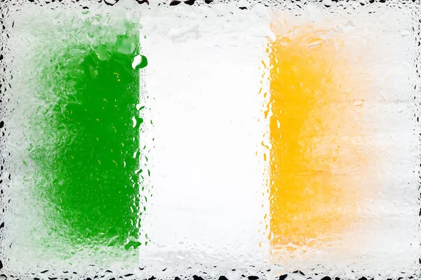 Ireland flag. Flag of Ireland on the background of water drops. Flag with raindrops. Splashes on glass. Abstract background