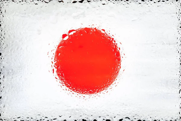 Japan flag. Flag of Japan on the background of water drops. Flag with raindrops. Splashes on glass. Abstract background