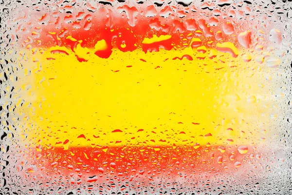 Flag of Spain. Spain flag on the background of water drops. Flag with raindrops. Splashes on glass. Abstract background