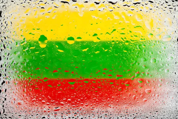 Flag of Lithuania. Lithuania flag on the background of water drops. Flag with raindrops. Splashes on glass. Abstract background