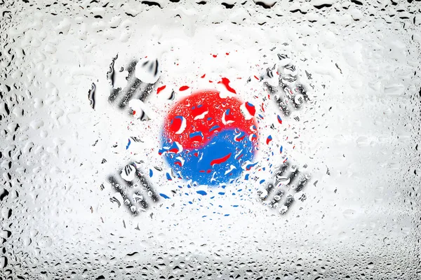 Flag of South Korea. South Korea flag on the background of water drops. Flag with raindrops. Splashes on glass. Abstract background