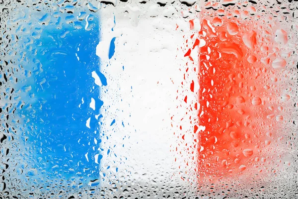 Flag of France. France flag on the background of water drops. Flag with raindrops. Splashes on glass. Abstract background