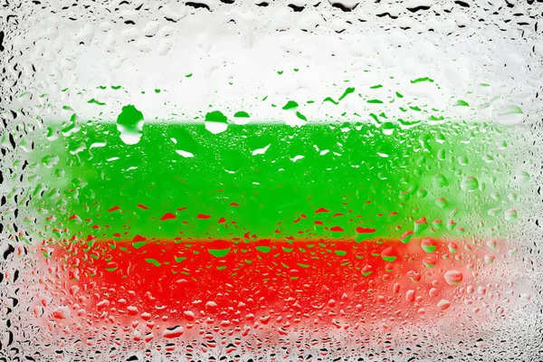 Flag of Bulgaria. Bulgaria flag on the background of water drops. Flag with raindrops. Splashes on glass. Abstract background