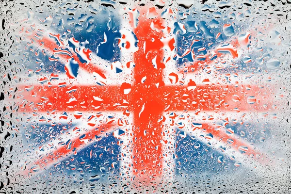 Flag of Britain. Great Britain flag on the background of water drops. Flag with raindrops. Splashes on glass. Abstract background