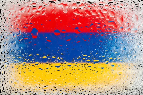 Flag of Armenia. Armenia flag on the background of water drops. Flag with raindrops. Splashes on glass. Abstract background
