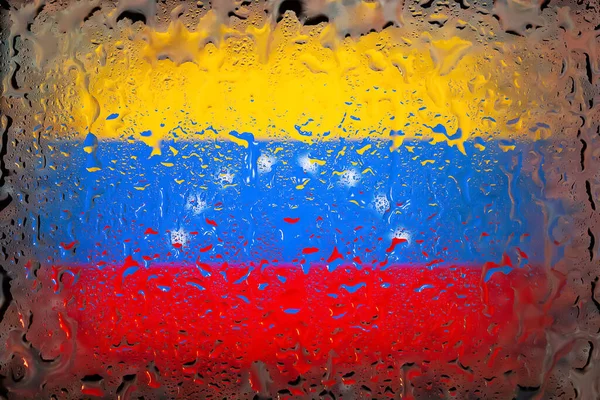 Venezuela flag. Venezuela flag on the background of water drops. Flag with raindrops. Splashes on glass. Abstract background