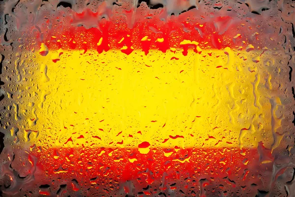 Spain flag. Spain flag on the background of water drops. Flag with raindrops. Splashes on glass. Abstract background
