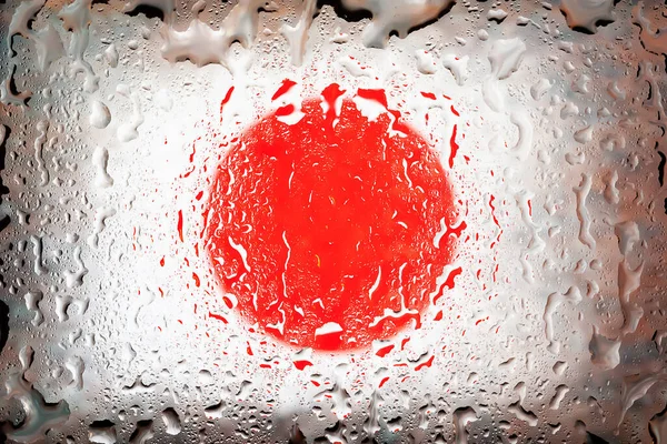 Japan flag. Japan flag on the background of water drops. Flag with raindrops. Splashes on glass. Abstract background