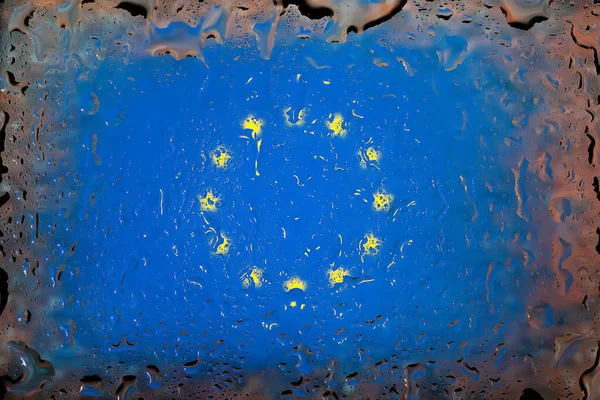 EU flag. European Union flag on the background of water drops. Flag with raindrops. Splashes on glass. Abstract background