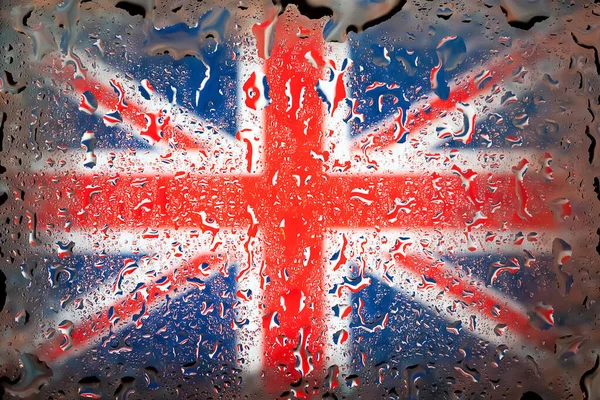 Great Britain flag. Britain flag on the background of water drops. Flag with raindrops. Splashes on glass. Abstract background