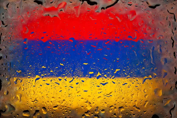 Armenian flag. Armenia flag on the background of water drops. Flag with raindrops. Splashes on glass. Abstract background