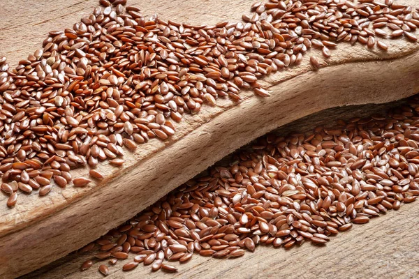 Flax seeds. Flax seeds are scattered on a wooden board close-up. Omega 3. Healthy food. Top view