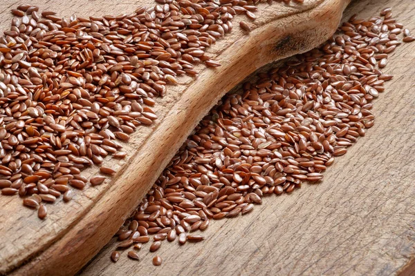 Flax seeds. Flax seeds are scattered on a wooden board close-up. Omega 3. Healthy nutrition. Top view