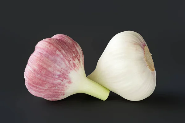 Raw garlic. Garlic heads on a black background. Selective focus