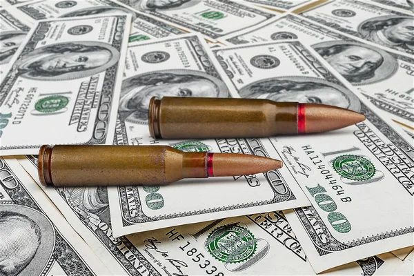 Bullets on dollar bills. Sale of arms. Military aid concept. Military mercenary. Funding for crime. Military financial support. Financial concept
