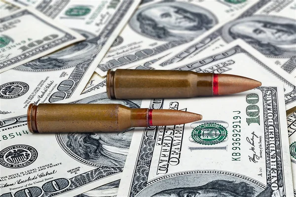 Bullets on dollar bills. Sale of weapons. The concept of military assistance. Military mercenary. Funding for crime. Military financial support. Financial concept