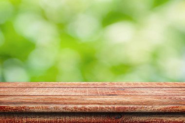 Tahta yüzey. Boyalı tahtalar. Eski masa. Doğal yeşil bulanık odaklı arka planda ahşap masa